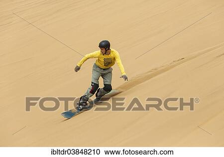 "Sand boarding in the dunes of the Namib Desert, near Swakopmund, Namibia, Africa" View Large Photo Image Stock Image - "Sand boarding in the dunes of the Namib Desert, near Swakopmund, Namibia, Africa". Fotosearch