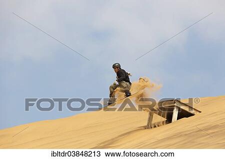 "Sand boarding in the dunes of the Namib Desert, near Swakopmund, Namibia, Africa" View Large Photo Image Stock Image - "Sand boarding in the dunes of the Namib Desert, near Swakopmund, Namibia, Africa". Fotosearch