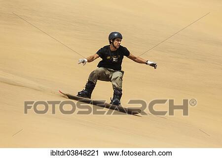 "Sand boarding in the dunes of the Namib Desert, near Swakopmund, Namibia, Africa" View Large Photo Image Stock Image - "Sand boarding in the dunes of the Namib Desert, near Swakopmund, Namibia, Africa". Fotosearch