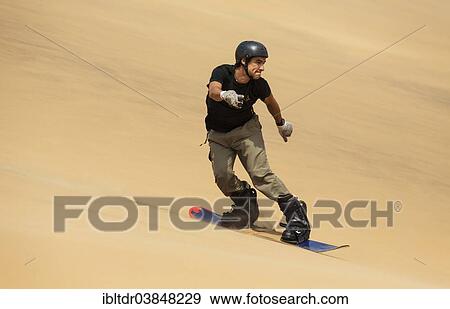 "Sand boarding in the dunes of the Namib Desert, near Swakopmund, Namibia, Africa" View Large Photo Image Stock Photo - "Sand boarding in the dunes of the Namib Desert, near Swakopmund, Namibia, Africa". Fotosearch