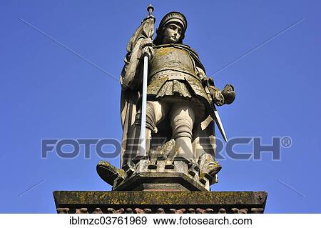 "Sandstone statue of St. Florian against a blue sky, Hassfurt, Lower Franconia, Bavaria, Germany, Europe" View Large Photo Image Stock Photo - "Sandstone statue of St. Florian against a blue sky, Hassfurt, Lower Franconia, Bavaria, Germany, Europe". Fotosearch