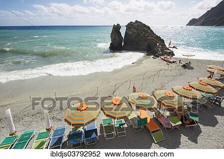 "Sandy beach and colorful sunshades, Monterosso al Mare, Cinque Terre, La Spezia Province, Liguria, Italy, Europe" View Large Photo Image Stock Image - "Sandy beach and colorful sunshades, Monterosso al Mare, Cinque Terre, La Spezia Province, Liguria, Italy, Europe". Fotosearch