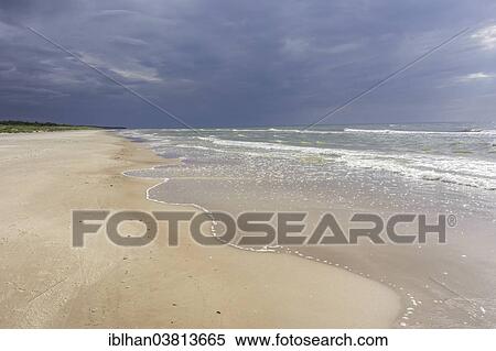 Stock Photography - "Sandy beach on the Baltic sea with storm clouds, Verbelnieki, Nica, Latvia, Europe". Fotosearch
