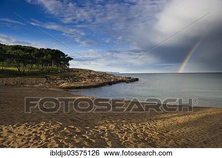 "Sandy beach with rainbow over the sea, L'Escala, Costa Brava, Catalonia, Spain, Europe" View Large Photo Image Stock Photograph - "Sandy beach with rainbow over the sea, L'Escala, Costa Brava, Catalonia, Spain, Europe". Fotosearch