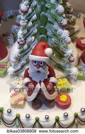 Stock Photo - "Santa Claus figure made of marzipan, decoration on a cake, in the window of a pastry shop, Dusseldorf, North Rhine-Westphalia, Germany, Europe". Fotosearch