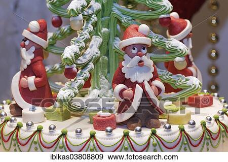 Stock Photo - "Santa Claus figures made of marzipan, decoration on a cake, in the window of a pastry shop, Dusseldorf, North Rhine-Westphalia, Germany, Europe". Fotosearch