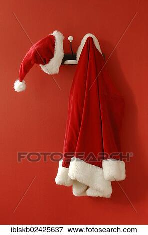 Stock Photo - Santa Claus hat and coat hanging on nostalgic coat hooks. Fotosearch