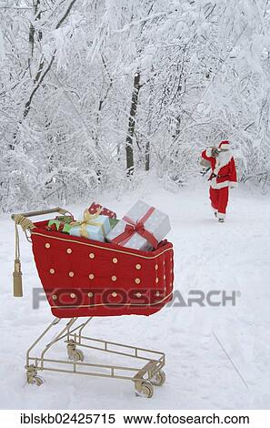 Santa Claus in a snowy forest with a shopping cart with red velvet and gifts in the foreground View Large Photo Image Stock Photography - Santa Claus in a snowy forest with a shopping cart with red velvet and gifts in the foreground. Fotosearch