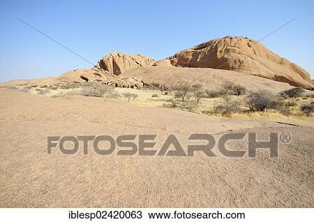 Stock Image - Savannah landscape with granite rocks and Spitzkoppe Mountain, Spitzkoppe, Grosse Spitzkuppe Nature Reserve, Namibia, Africa. Fotosearch