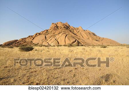 Stock Image - Savannah landscape with granite rocks of the Pontok Mountains, Spitzkoppe, Grosse Spitzkuppe Nature Reserve, Namibia, Africa. Fotosearch