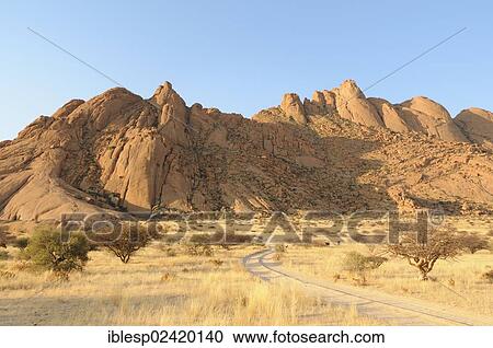 Savannah landscape with granite rocks of the Pontok Mountains, Spitzkoppe, Grosse Spitzkuppe Nature Reserve, Namibia, Africa View Large Photo Image Stock Image - Savannah landscape with granite rocks of the Pontok Mountains, Spitzkoppe, Grosse Spitzkuppe Nature Reserve, Namibia, Africa. Fotosearch