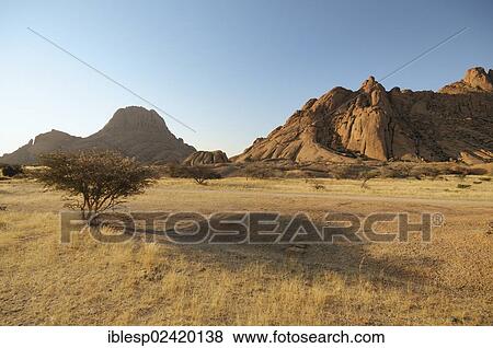 Savannah landscape with granite rocks of Spitzkoppe Mountain and the Pontok Mountains, Spitzkoppe, Grosse Spitzkuppe Nature Reserve, Namibia, Africa View Large Photo Image Stock Photo - Savannah landscape with granite rocks of Spitzkoppe Mountain and the Pontok Mountains, Spitzkoppe, Grosse Spitzkuppe Nature Reserve, Namibia, Africa. Fotosearch