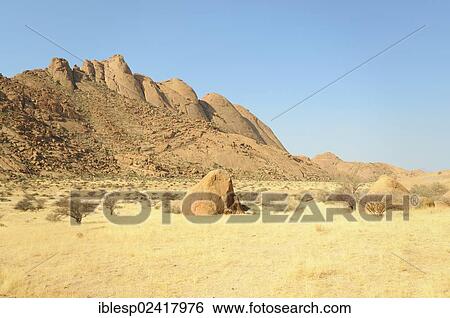 Stock Photograph - Savannah landscape with granite rocks and Spitzkoppe Mountain, Pontok Mountains, Grosse Spitzkuppe Nature Reserve, Namibia, Africa. Fotosearch