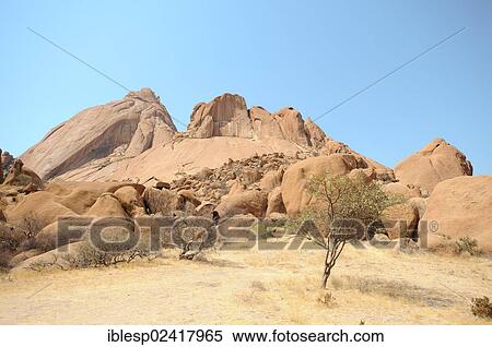 Stock Photography - Savannah landscape with granite rocks and Spitzkoppe Mountain, Grosse Spitzkuppe Nature Reserve, Namibia, Africa. Fotosearch