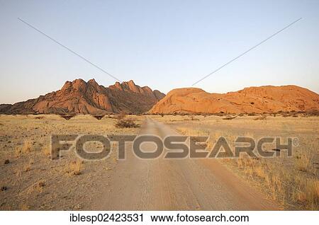 Stock Image - Savannah landscape with rock formations, Spitzkoppe and Pontok Mountains, Great Spitzkoppe Nature Reserve, Namibia, Africa. Fotosearch