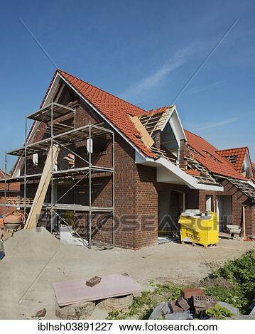"Scaffolded newly built house, completion of the roof, Aurich, Lower Saxony, Germany, Europe" View Large Photo Image Stock Photo - "Scaffolded newly built house, completion of the roof, Aurich, Lower Saxony, Germany, Europe". Fotosearch