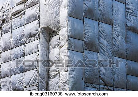 "Scaffolding surrounded by a silver plastic tarp, protection from falling components, Frankfurt am Main, Hesse, Germany, Europe" View Large Photo Image Stock Photo - "Scaffolding surrounded by a silver plastic tarp, protection from falling components, Frankfurt am Main, Hesse, Germany, Europe". Fotosearch
