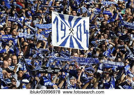 "Schalke fans on the north stand holding up scarves and a banner """"1904"""", FC Schalke 04 - Borussia Dortmund, Veltins Arena, Gelsenkirchen, North Rhine-Westphalia, Germany, Europe" View Large Photo Image Stock Photo - "Schalke fans on the north stand holding up scarves and a banner """"1904"""", FC Schalke 04 - Borussia Dortmund, Veltins Arena, Gelsenkirchen, North Rhine-Westphalia, Germany, Europe". Fotosearch