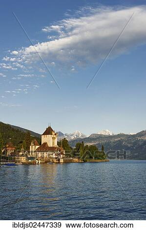 "Schloss Oberhofen Castle on Lake Thun, Bernese Oberland with the mountains Moench, Eiger and Jungfrau at back, Bernese Oberland, Switzerland, Europe" View Large Photo Image Stock Photo - "Schloss Oberhofen Castle on Lake Thun, Bernese Oberland with the mountains Moench, Eiger and Jungfrau at back, Bernese Oberland, Switzerland, Europe". Fotosearch
