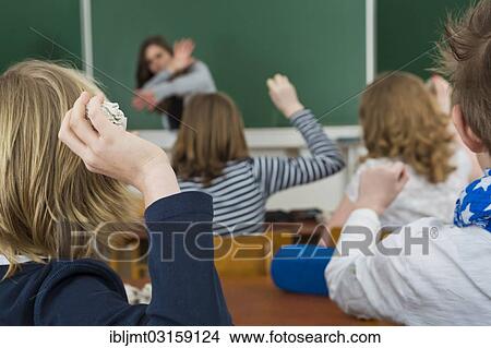 "School children in a classroom throwing paper balls at the teacher, bullying against teachers, Germany, Europe" View Large Photo Image Picture - "School children in a classroom throwing paper balls at the teacher, bullying against teachers, Germany, Europe". Fotosearch
