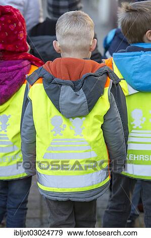 "School children wearing high-visibility vests with the signal word """"Verkehrsdetektiv"""", German for """"traffic detective"""", Germany, Europe" View Large Photo Image Stock Photo - "School children wearing high-visibility vests with the signal word """"Verkehrsdetektiv"""", German for """"traffic detective"""", Germany, Europe". Fotosearch