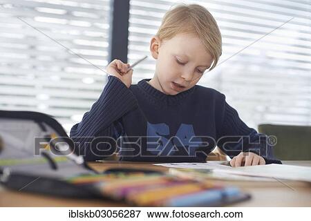 Stock Photo - "Schoolboy, 7 years, doing his homework, Germany, Europe". Fotosearch