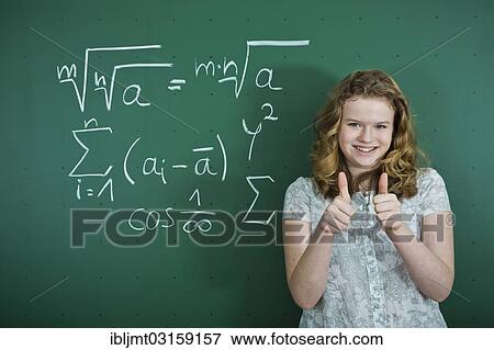 "Schoolgirl standing in front of a school blackboard with mathematical formulas, making a thumbs-up gesture, Germany, Europe" View Large Photo Image Stock Photo - "Schoolgirl standing in front of a school blackboard with mathematical formulas, making a thumbs-up gesture, Germany, Europe". Fotosearch