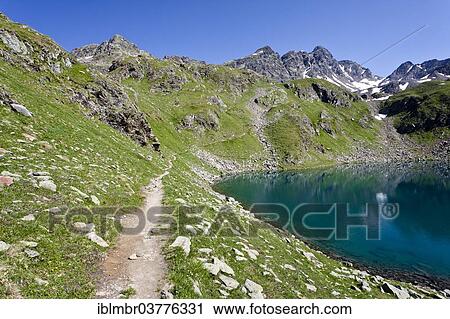 Stock Image - "Schwarzsee Lake, with the mountains Schwarzwandscharte and Hofmannspitz at back, South Tyrol, Trentino-Alto Adige, Italy, Europe". Fotosearch