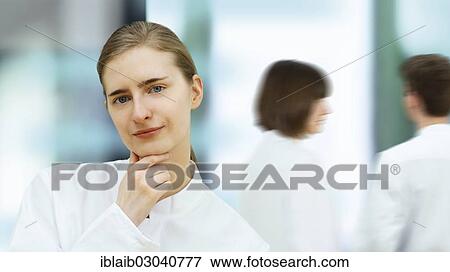 Scientist in front of her team View Large Photo Image Stock Photo - Scientist in front of her team. Fotosearch