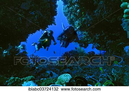 "Scuba divers in a cave, Raja Ampat, West Papua, Indonesia, Asia" View Large Photo Image Stock Image - "Scuba divers in a cave, Raja Ampat, West Papua, Indonesia, Asia". Fotosearch