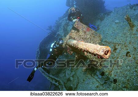 "Scuba divers looking at anti-aircraft gun on the stern of the shipwreck """"SS Thistlegorm"""", Red Sea, Egypt, Africa" View Large Photo Image Stock Photograph - "Scuba divers looking at anti-aircraft gun on the stern of the shipwreck """"SS Thistlegorm"""", Red Sea, Egypt, Africa". Fotosearch