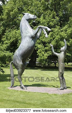"Sculpture of a horse and a trainer in the park at Celle Castle, Celle, Lower Saxony, Germany, Europe" View Large Photo Image Stock Photo - "Sculpture of a horse and a trainer in the park at Celle Castle, Celle, Lower Saxony, Germany, Europe". Fotosearch