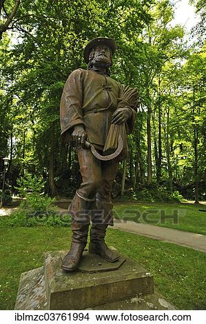"Sculpture of a spelt farmer holding a sickle and a bundle of grain, in the Stadtpark city park, Dinkelsbuhl, Middle Franconia, Bavaria, Germany, Europe" View Large Photo Image Picture - "Sculpture of a spelt farmer holding a sickle and a bundle of grain, in the Stadtpark city park, Dinkelsbuhl, Middle Franconia, Bavaria, Germany, Europe". Fotosearch