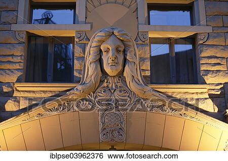 Stock Photograph - "Sculpture of a woman's head over the Art Nouveau entrance of the Neiburgs Hotel, Riga, Latvia, Europe". Fotosearch
