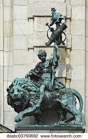 "Sculpture of a young man riding a lion, on the facade of the Bavarian National Museum, Munich, Upper Bavaria, Bavaria, Germany, Europe" View Large Photo Image Stock Image - "Sculpture of a young man riding a lion, on the facade of the Bavarian National Museum, Munich, Upper Bavaria, Bavaria, Germany, Europe". Fotosearch