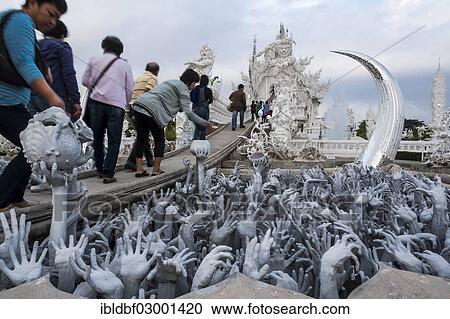 Stock Image - "Sculpture of the creatures of hell, sacrificial offerings, Wat Rong Khun temple or The White Wat, a Buddhist-Hindu temple by architect Chalermchai Kositpipat, Chiang Rai, Chiang Rai Province, Northern Thailand, Thailand, Asia". Fotosearch