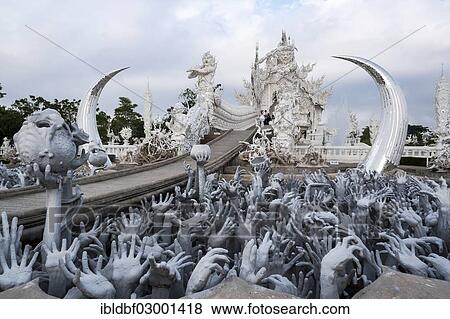 Stock Photo - "Sculpture of the creatures of hell, Wat Rong Khun temple or The White Wat, a Buddhist-Hindu temple by architect Chalermchai Kositpipat, Chiang Rai, Chiang Rai Province, Northern Thailand, Thailand, Asia". Fotosearch