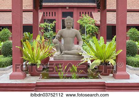 Stock Image - "Sculpture of Yama, the leper king, from the terrace of the leper king, Angkor Thom, Siem Reap, Angkorian period, 13th century, sandstone, copy of the original kept inside the museum, National Museum of Cambodia, Phnom Penh, Cambodia, Asia". Fotosearch