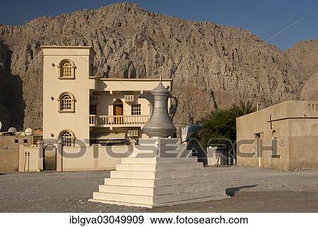 "Scuplture of a traditional Arabian coffee pot as a symbol of Arab tradition and hospitality, Khasab, Musandam Governorate, Oman, Asia" View Large Photo Image Stock Photo - "Scuplture of a traditional Arabian coffee pot as a symbol of Arab tradition and hospitality, Khasab, Musandam Governorate, Oman, Asia". Fotosearch