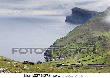 Stock Photo - "Sea, clouds, cliffs, village threatened by depopulation, Hattarvik, Fugloy, Norooyar, Faroe Islands, Denmark, Europe". Fotosearch
