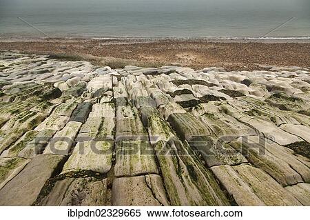 Sea defence laid stones on beach worn down by the action of water View Large Photo Image Stock Photography - Sea defence laid stones on beach worn down by the action of water. Fotosearch
