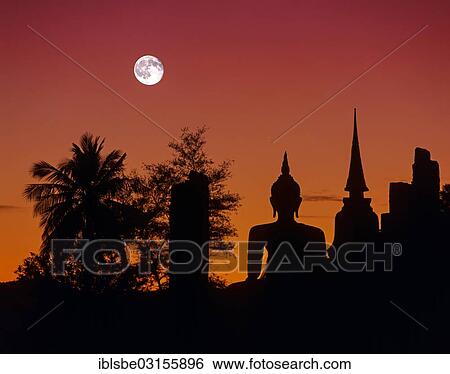 Stock Photograph - "Seated Buddha at Wat Mahathat, silhouette at dusk, full moon, Sukhothai Historical Park, Sukhothai, Sukhothai Province, Northern Thailand, Thailand, Asia". Fotosearch