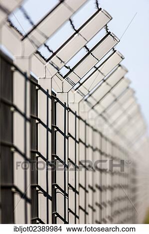 Security fence with barbed wire on top View Large Photo Image Picture - Security fence with barbed wire on top. Fotosearch