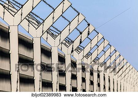 Security fence with barbed wire on top View Large Photo Image Stock Image - Security fence with barbed wire on top. Fotosearch