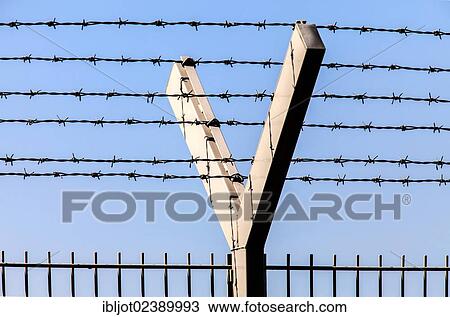 Security fence with barbed wire on top View Large Photo Image Stock Image - Security fence with barbed wire on top. Fotosearch