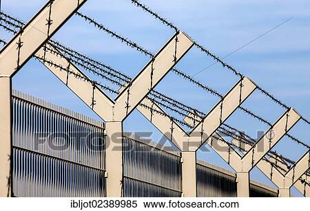 Security fence with barbed wire on top View Large Photo Image Stock Photography - Security fence with barbed wire on top. Fotosearch