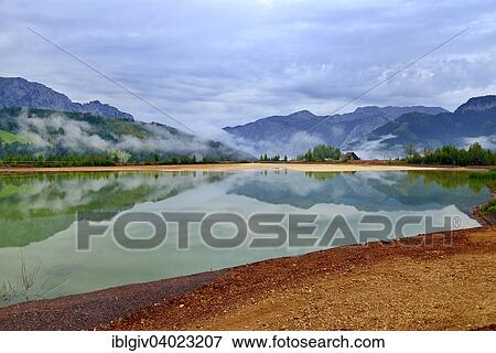 Stock Photo - "Sedimentation pool, sludge pond in the mining area of â€‹â€‹the open pit mine, Erzberg mountain at Eisenerz, Styria, Austria, Europe". Fotosearch
