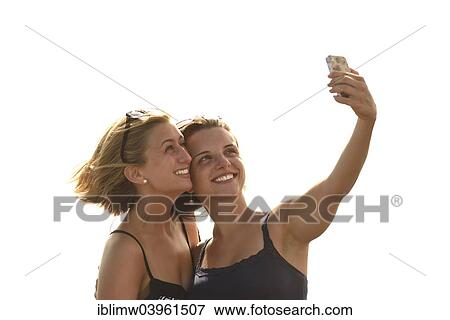 "Selfie, two young women taking a self-portrait with a mobile phone, Lanzarote, Canary Islands, Spain, Europe" View Large Photo Image Stock Photo - "Selfie, two young women taking a self-portrait with a mobile phone, Lanzarote, Canary Islands, Spain, Europe". Fotosearch