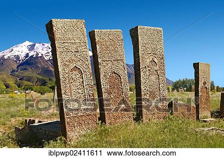 Stock Image - Seljuk headstones with Arabic and Persian floral, geometric and calligraphic decorations in the Seljuk Cemetery at Ahlat, Lake Van, Turkey, Asia. Fotosearch