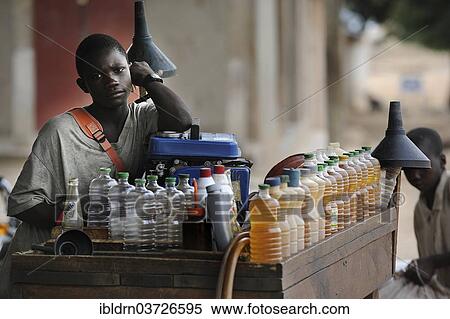 "Seller of motorcycle petrol, Tourou, Far North, Cameroon, Africa" View Large Photo Image Stock Photography - "Seller of motorcycle petrol, Tourou, Far North, Cameroon, Africa". Fotosearch